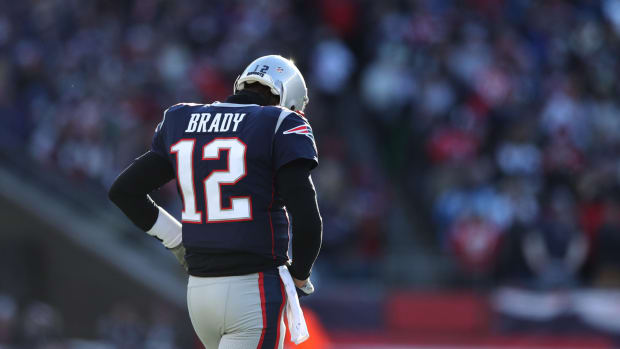 New England Patriots QB Tom Brady taking the field during a game.