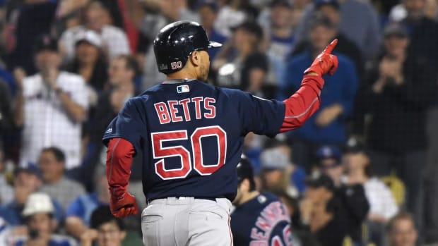 Mookie Betts celebrating after hitting a home run.