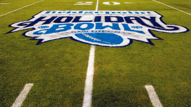 A close-up of the Holiday Bowl logo on the field.