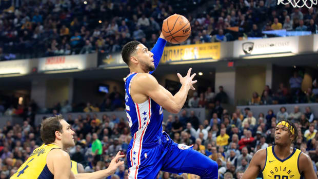 Ben Simmons going up for a dunk during a game.