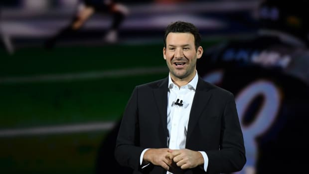 Tony Romo speaking at an event.