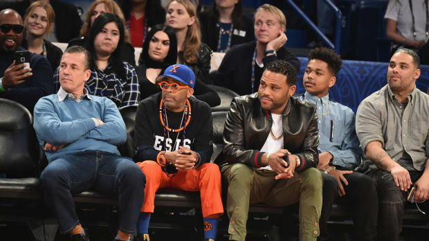 Spike Lee sitting court side with Anthony Anderson.