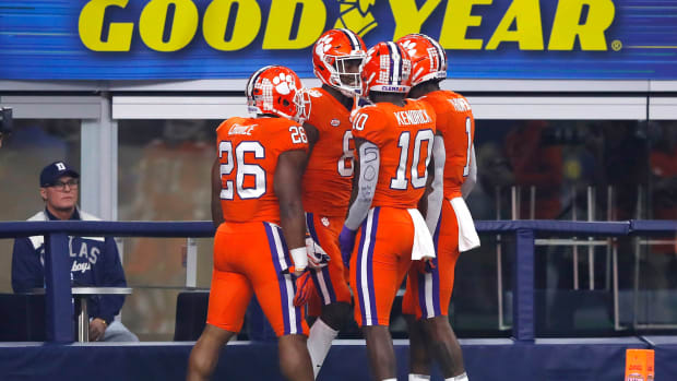 Justyn Ross celebrates with Clemson teammates including Derion Kendrick after touchdown.