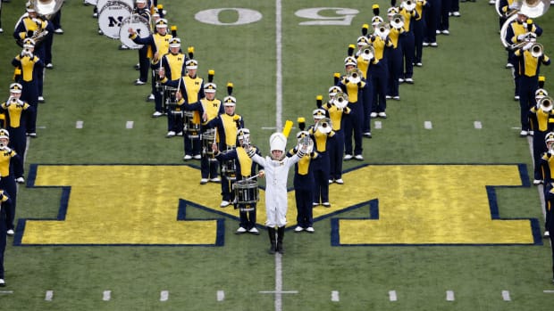 The Michigan Wolverines marching band performs before the college football game against the Michigan State Spartans at Michigan Stadium.