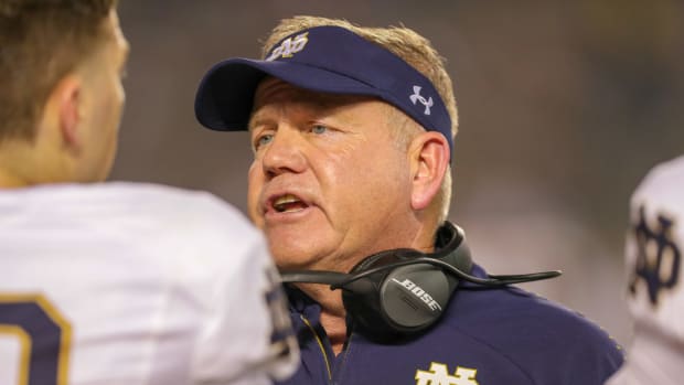 A closeup of Notre Dame football coach Brian Kelly talking to his players.