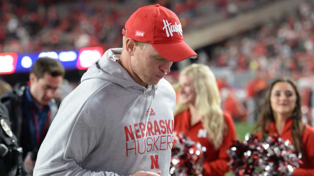 Nebraska football head coach Scott Frost runs off the field after a loss to Ohio State.