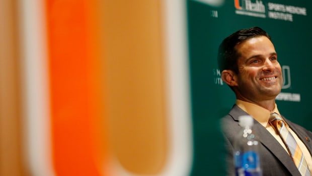 Manny Diaz speaking at a Miami Hurricanes press conference.
