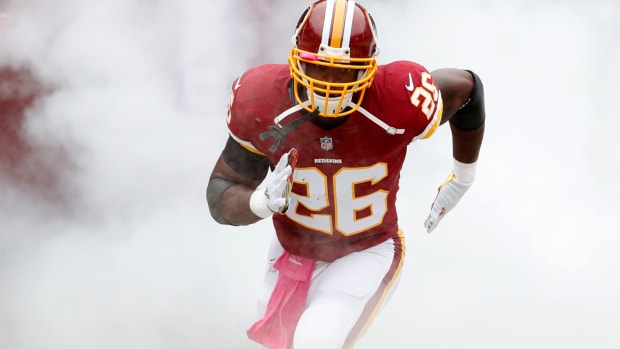 Adrian Peterson running onto the field prior to a Redskins game.