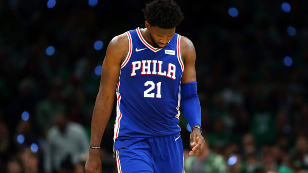 Joel Embiid with his head down during a game.