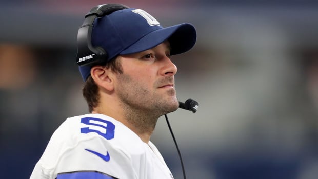 Tony Romo on the sideline with a headset on.