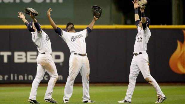 Three Milwaukee Brewers outfielders celebrating a win.