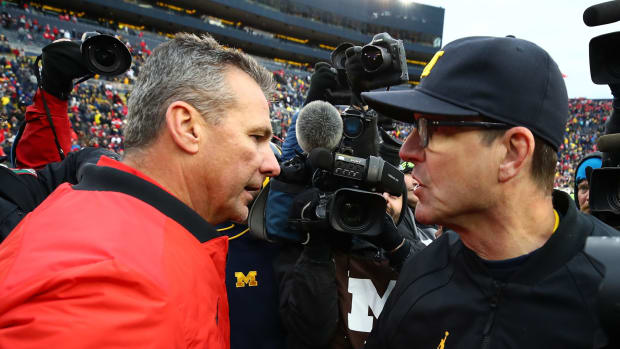 Urban Meyer and Jim Harbaugh meet after an Ohio State-Michigan game.