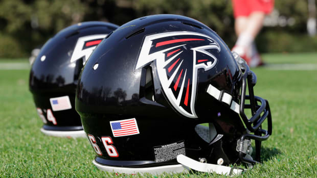 Atlanta Falcons helmets sitting on the field.