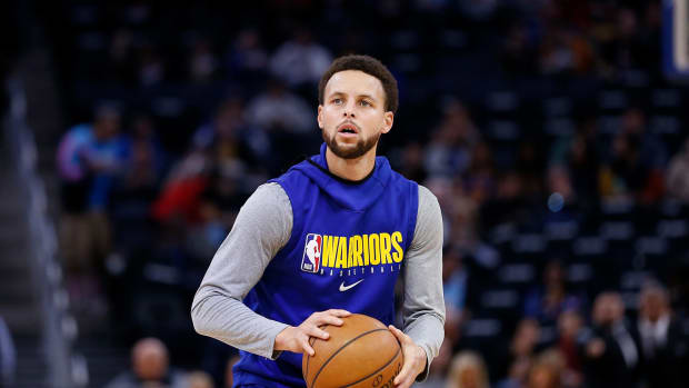 Golden State Warriors point guard Steph Curry warms up.