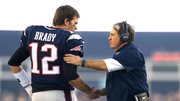 Tom Brady talking to Bill Belichick.