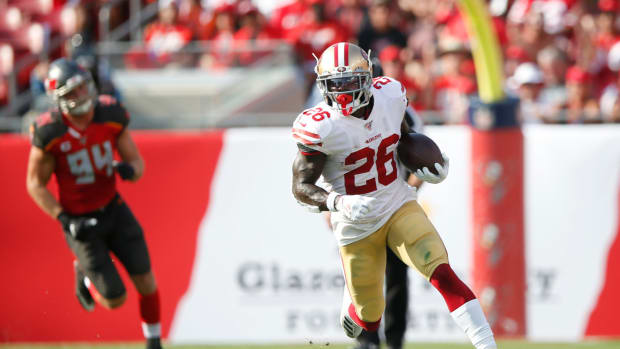Tevin Coleman runs the football for the San Francisco 49ers.