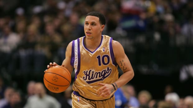 Sacramento Kings point guard Mike Bibby in a gold jersey.