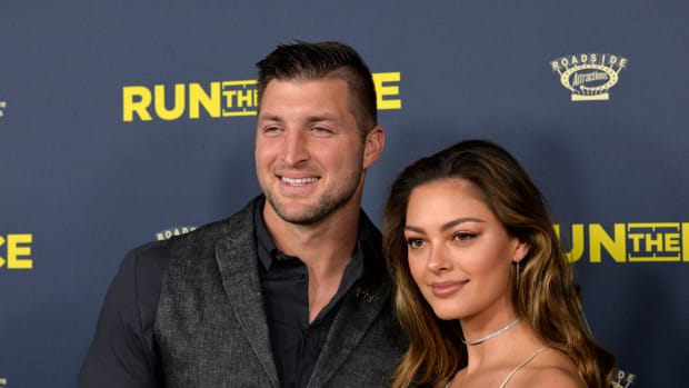 Tim Tebow and Demi-Leigh Nel-Peters pose for a photo.