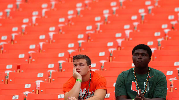 A picture of two sad Miami Hurricanes fans.