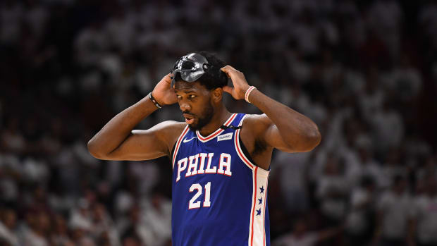 Joel Embiid taking off his mask.