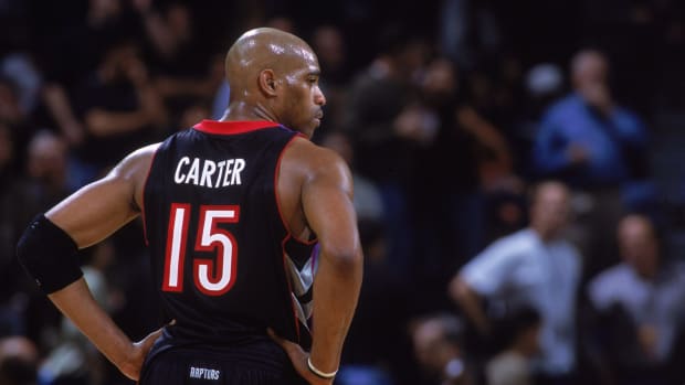 vince carter looks onto the court during a game