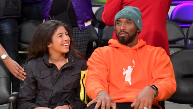 Kobe Bryant and his daughter Gianna watch an NBA game.