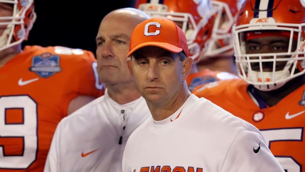 A closeup of Clemson head coach Dabo Swinney standing with his players.