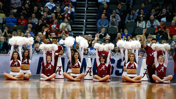 Alabama cheerleaders performing during a basketball game.