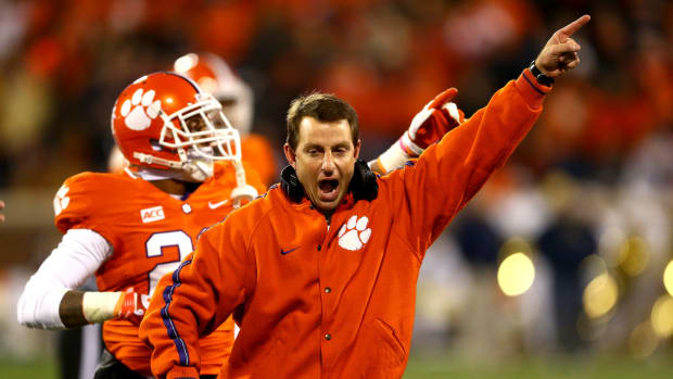 Head coach Dabo Swinney of the Clemson Tigers celebrates after a ruling on the field during their game against the Georgia Tech Yellow Jackets at Clemson Memorial Stadium.