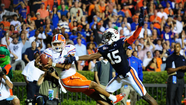 Jordan Reed #11 of the Florida Gators is unable to hold on to a pass against Neiko Thorpe #15 of the Auburn Tigers at Jordan-Hare Stadium.