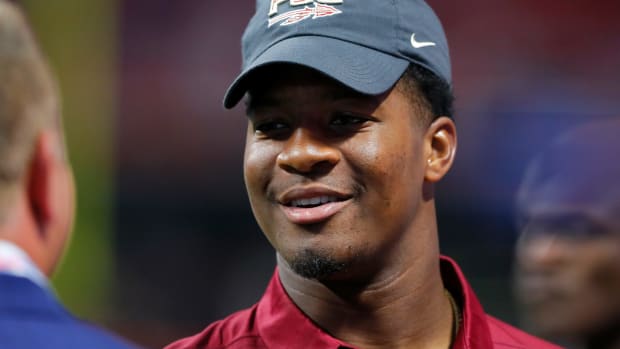 A closeup of Jameis Winston wearing a black Florida State hat.