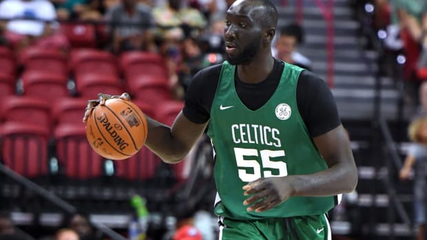 Boston Celtics center Tacko Fall takes the ball up the floor.