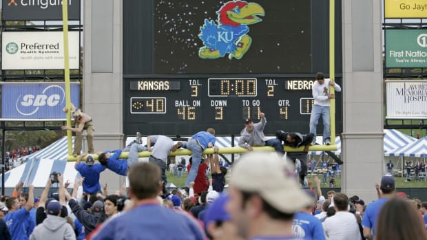 Kansas fans tearing down the goal post after the football team wins.