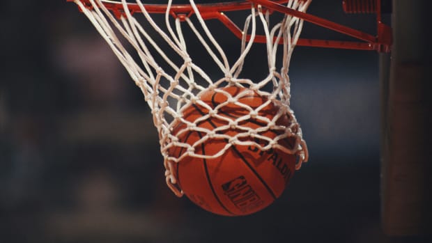 photo of a basketball going through the net