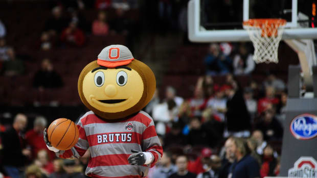 A closeup of Ohio State's mascot dribbling a basketball.