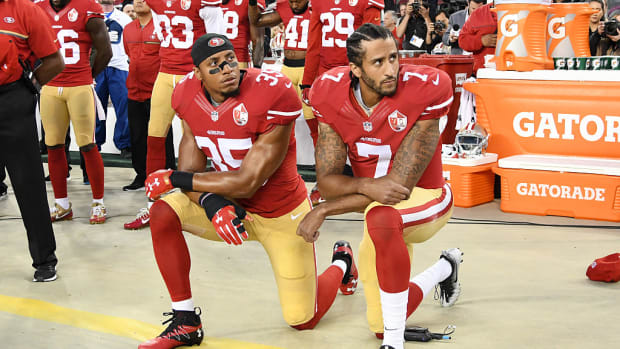 Colin Kaepernick #7 and Eric Reid #35 of the San Francisco 49ers kneel in protest during the national anthem.