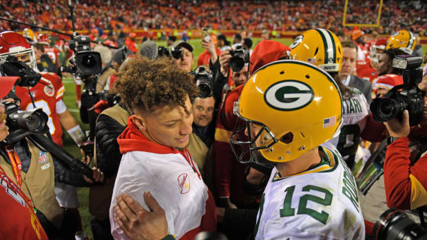 Patrick Mahomes and Aaron Rodgers meet on the field.