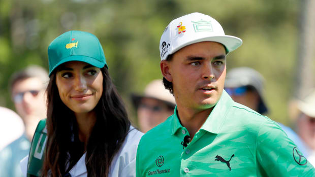 Rickie Fowler standing with his fiancee Allison Stokke.