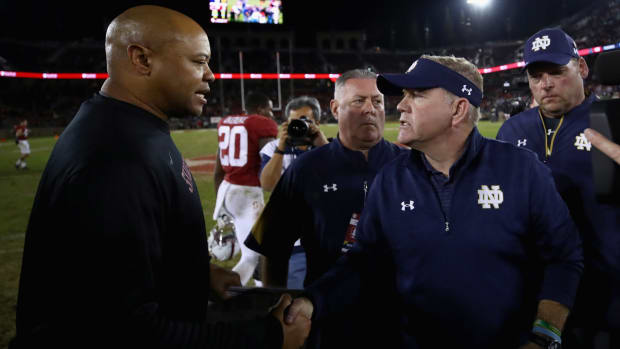 Notre Dame coach Brian Kelly shaking hands with Stanford coach David Shaw after a game.