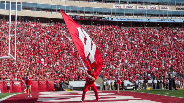 Wisconsin's cheerleader waves the flag in the end zone for Badgers fans.