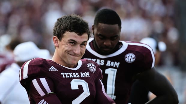 Johnny Manziel smiling in his Texas A&M football uniform.