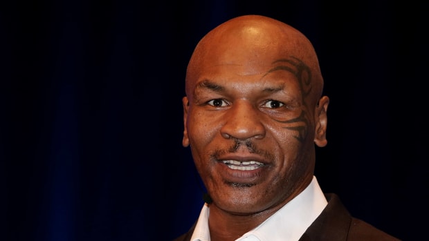 mike tyson speaks on stage at an event