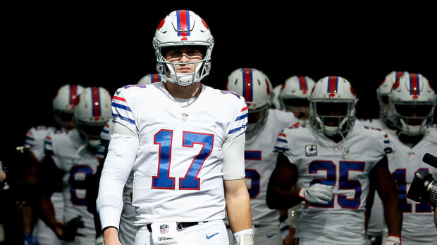 Josh Allen leading the Bills onto the field for an NFL game.