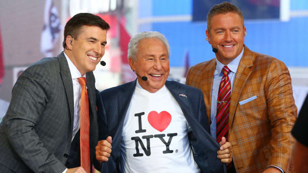 Lee Corso wearing an I Love New York T-Shirt while posing for a photo with Kirk Herbstreit and Chris Fowler on a College GameDay episode.