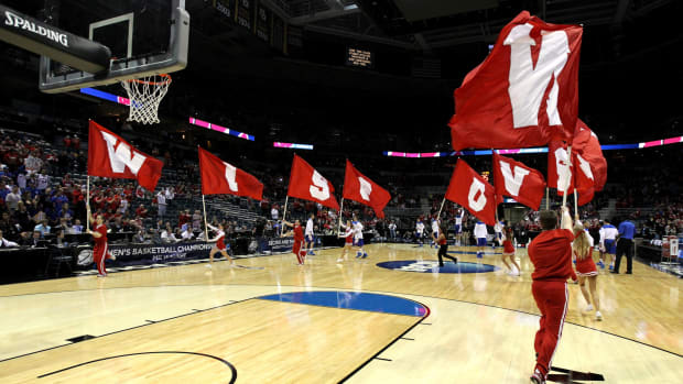 Wisconsin basketball cheerleaders fly Wisconsin banners at the NCAA Tournament in 2014.