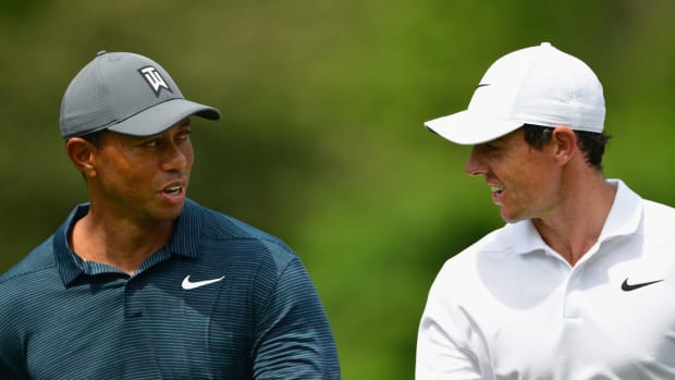 Tiger Woods and Rory McIlroy walk the course.