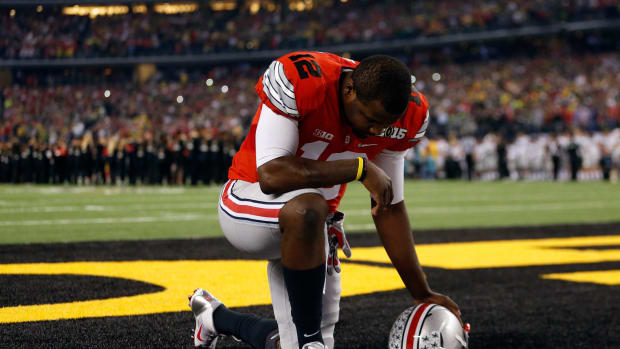 Cardale Jones kneeling in the end zone before a game.