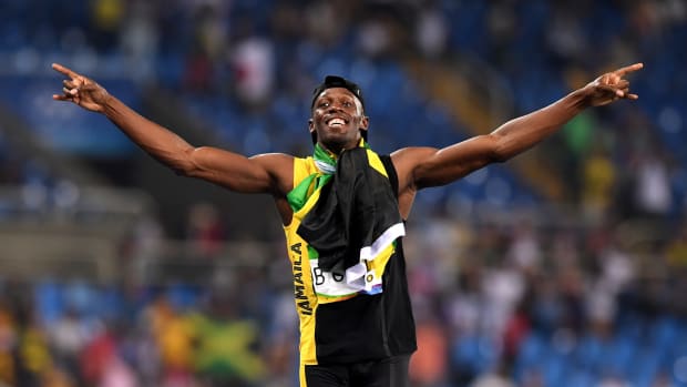 Usain Bolt celebrates winning an olympic event.