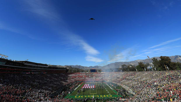 Stealth bomber flies over college football game at the Rose Bowl game between Big Ten and Pac-12 teams..