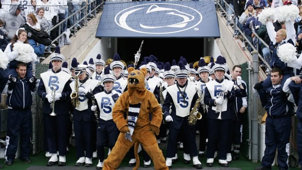 Penn State's mascot leads the band onto the field.